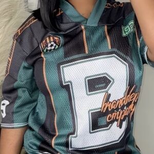 Green and Black Sports Jersey with Mesh Texture and Short Sleeves